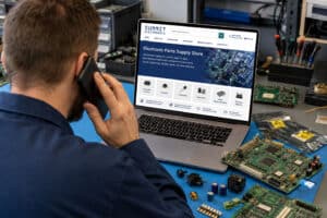 MRO technician calling Summit Electronics while sourcing hard-to-find electronic components from a laptop at a repair workbench.